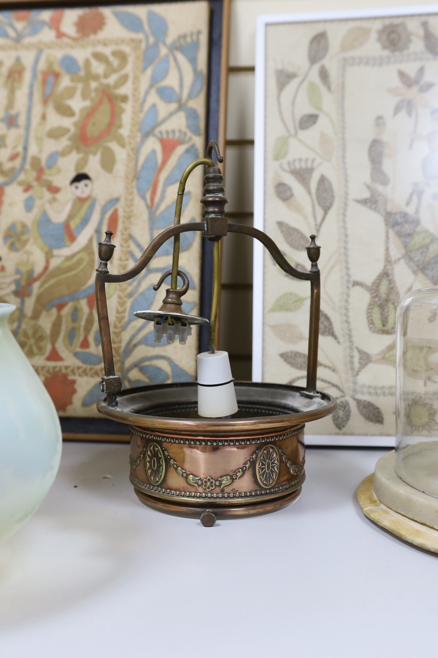 An embossed copper ceiling light with vaseline glass shade, and Far Famed Cake Co. cake stand and domed cover